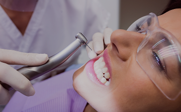 Dentist adjusts patient's braces with a specialized tool during a close-up dental procedure
